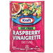 A pink Kraft packet of fat-free raspberry vinaigrette salad dressing.