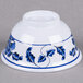 A white Thunder Group melamine rice bowl with a blue lotus design.