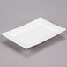A bright white rectangular porcelain platter with a thin edge.