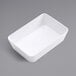 An American Metalcraft white rectangular plastic serving bowl on a gray surface.