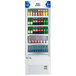 An Avantco white refrigerated air curtain merchandiser filled with soda and pop bottles.