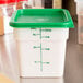 A white Cambro CamSquares polyethylene food storage container with a green lid.
