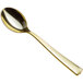A Visions gold plastic tasting spoon with a handle.