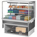 A Turbo Air drop-in refrigerated display case with drinks and cans on shelves.