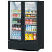 A Turbo Air refrigerated glass door merchandiser filled with yellow beverages.