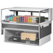 A Turbo Air white drop-in refrigerated open display case filled with drinks on a counter.