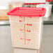 A Cambro translucent polypropylene square food storage container filled with pasta.