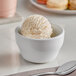 A white bowl with a scoop of Oringer ginger ice cream.
