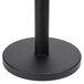 A black metal Aarco crowd control stanchion base with a black pole.
