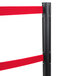 A black Aarco crowd control stanchion with red tape on the pole.
