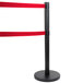 A black pole with dual red tape on it.
