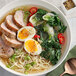 A bowl of ramen with meat, vegetables and greens topped with McCormick Culinary Asian Spiced Sea Salt.