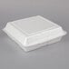 A Dart white styrofoam hinged lid takeout container.