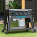 A black Pit Boss gas griddle with blue lettering on a table outdoors.