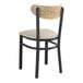A Lancaster Table & Seating Boomerang Series black chair with a light gray vinyl seat and driftwood back.