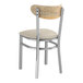 A Lancaster Table & Seating Boomerang Series chair with a light gray cushion and driftwood back.