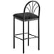 A Lancaster Table & Seating black bar stool with black fabric cushion and back.