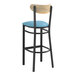 A Lancaster Table & Seating Boomerang Series black bar stool with blue vinyl cushion and driftwood back.