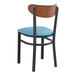 A Lancaster Table & Seating Boomerang Series chair with a blue vinyl seat and antique walnut back.