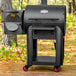 A black Louisiana Grills barbecue grill with the lid open.