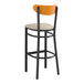 A Lancaster Table & Seating black bar stool with a light gray seat and cherry wood back.