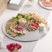 A Choice aluminum tray with a variety of food on it on a table.