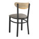 A Lancaster Table & Seating Boomerang Series black chair with a dark gray vinyl seat and driftwood back.
