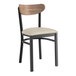 A black Lancaster Table & Seating chair with a wooden back and light gray cushion.