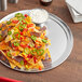 A Choice aluminum tray of nachos with sauce.