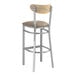 A Lancaster Table & Seating bar stool with a taupe vinyl seat and driftwood back.