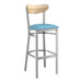A Lancaster Table & Seating bar stool with a blue vinyl seat and driftwood back.