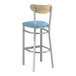 A Lancaster Table & Seating Boomerang bar stool with a blue vinyl seat.