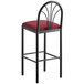 A Lancaster Table & Seating black bar stool with a merlot fabric seat detached.