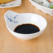 A Blue Bamboo melamine saucer with a bowl of rice and soy sauce.