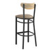 A Lancaster Table & Seating black wood bar stool with a taupe cushion and driftwood back.