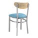 A Lancaster Table & Seating metal chair with a blue vinyl seat and driftwood back.
