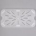 A white translucent plastic Cambro drain tray with holes.