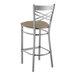 A Lancaster Table & Seating metal cross back bar stool with a taupe vinyl cushion