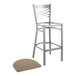 A brown Lancaster Table & Seating metal cross back bar stool with a taupe cushion.