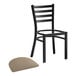 A Lancaster Table & Seating black ladder back chair with taupe vinyl padding.