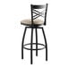 A black Lancaster Table & Seating swivel bar stool with light gray vinyl padded seat.