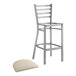 A Lancaster Table & Seating metal ladder back bar stool with a light gray cushion on the seat.