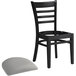 A Lancaster Table & Seating black wood ladder back restaurant chair with detached seat.
