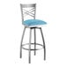 A Lancaster Table & Seating bar stool with a blue cushion on the seat.