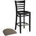 A Lancaster Table & Seating black wood ladder back bar stool with a taupe vinyl seat.