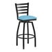 A Lancaster Table & Seating black ladder back bar stool with a blue vinyl padded seat.