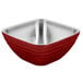 A red and stainless steel Vollrath beehive serving bowl.