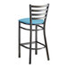 A Lancaster Table & Seating distressed copper metal ladder back bar stool with a blue vinyl padded seat.