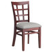 A Lancaster Table & Seating mahogany wood chair with a light gray cushion on the seat and back.