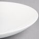 A close-up of a Homer Laughlin Alexa Ameriwhite bright white china salad plate with a rim.